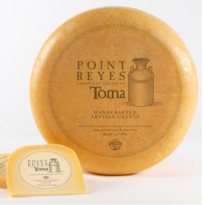 A wedge of Toma cheese, available at our Palm Springs liquor store, Perry's.