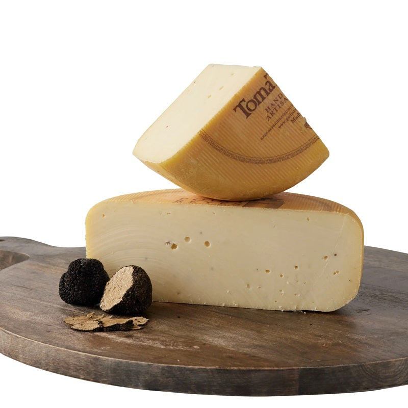 A wedge of Toma cheese, available at our Palm Springs liquor store, Perry's.